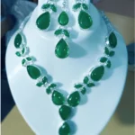 green stone necklace set with earrings and maang tikka