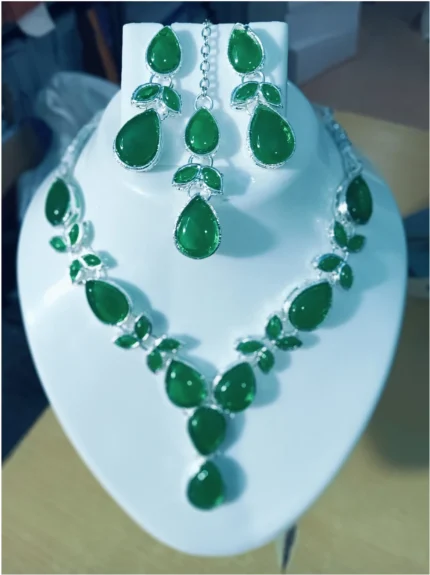 green stone necklace set with earrings and maang tikka
