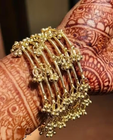 mehndi hand wearing gold bangles