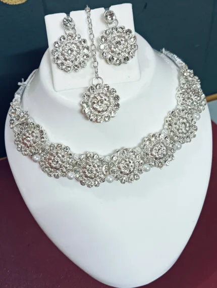 floral crystal necklace set with pearl detailing earrings and maang tikka bridal jewellery